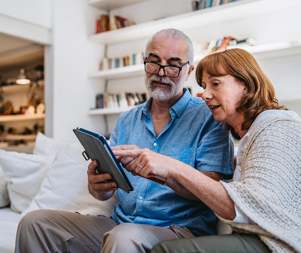 middle aged couple viewing tablet
