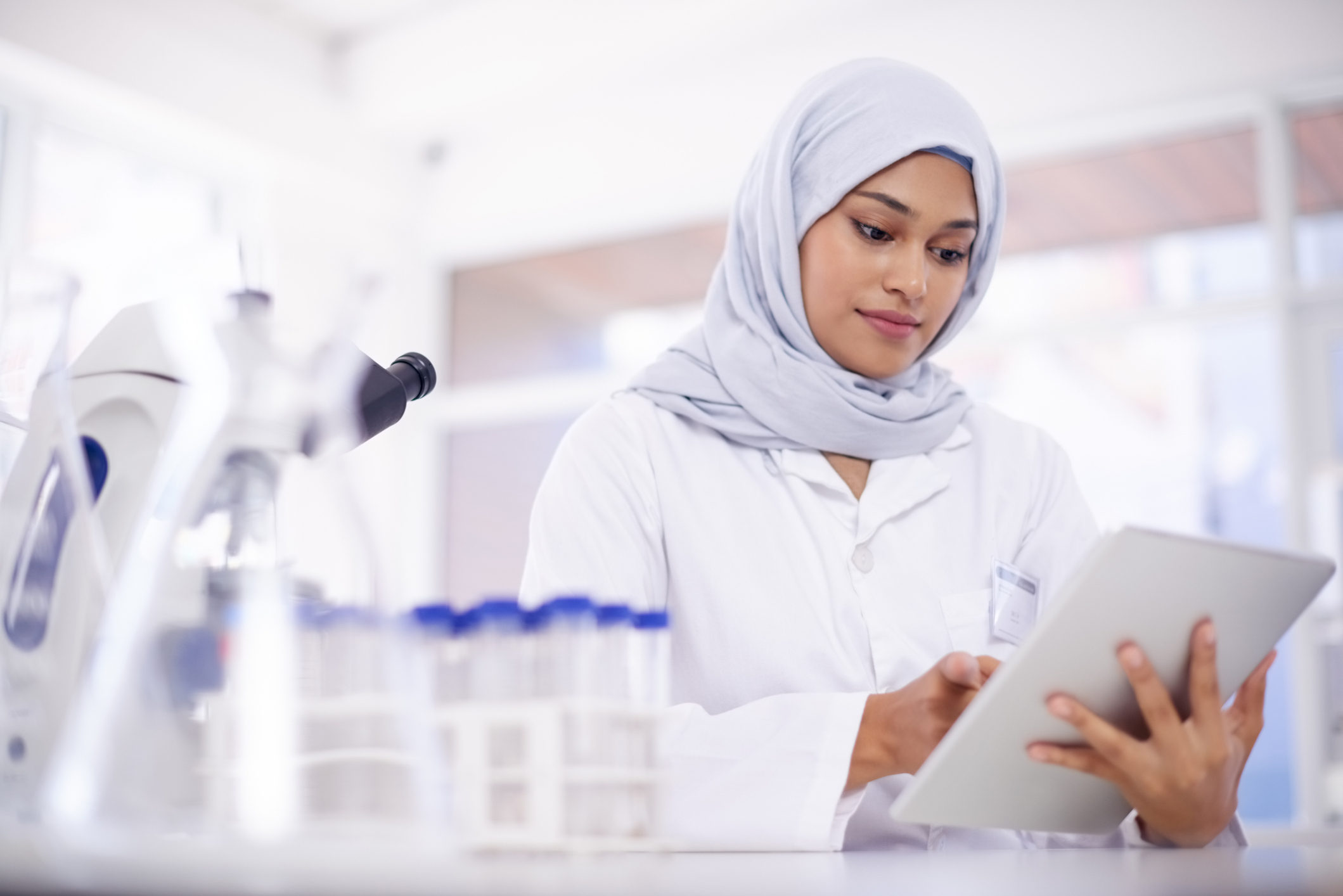 Shot of a young scientist using a digital tablet in a lab